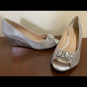 New. Never worn. Silver Antonio Melani wedges.